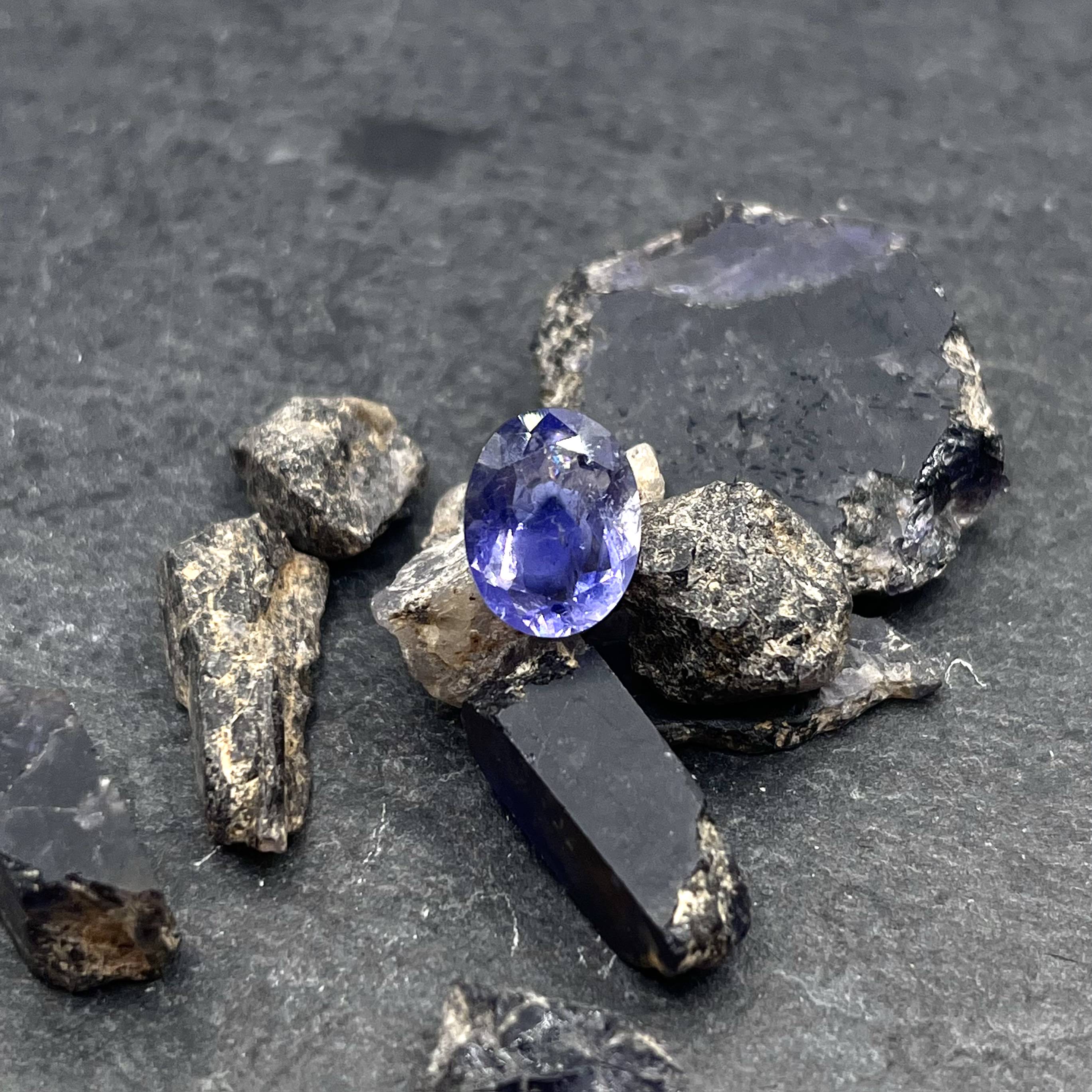 A 3.48ct faceted iolite with one lot of rough iolite crystals.